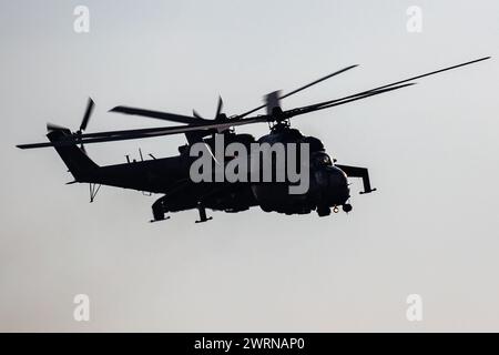 Szolnok, Hungary - August 17, 2022: Hungarian Air Force Mil Mi-24 Hind military attack helicopter. Flight operation. Aviation industry and rotorcraft. Stock Photo