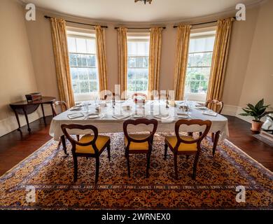Dining room with table set for dinner at Quarry Bank House. Styal. Cheshire. Stock Photo