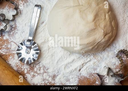 forms for squeezing the dough. dough on the table with dough tools. Stock Photo