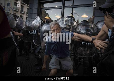 Buenos Aires, Argentina. 2nd Feb, 2024. A protester staggers after being pepper sprayed in the face by police during the demonstration The Omnibus Law of more than 600 articles presented by President Javier Milei brought dozens of hours of parliamentary debate, accompanied by several days of popular resistance in the streets surrounding the National Congress. These days were marked by the political thread, the negotiation, the back and forth, the protest and the repression. The year of 2024 in Buenos Aires, Argentina, began with tear gas, sticks, rubber bullets and laws that rose and fell b Stock Photo