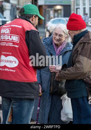 7 March 2024. Inverness,Scotland. This is an elderly couple shopping with a Big Issue Vendor in the City Centre of Inverness Stock Photo