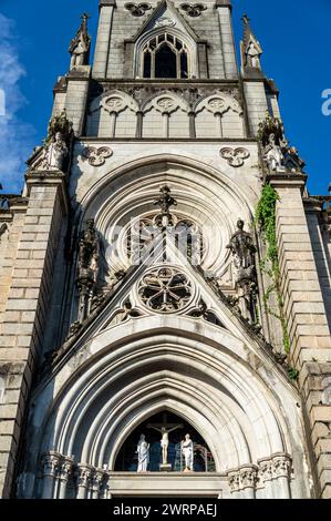 Close view of the main entrance facade details of Cathedral of Petropolis church in Centro district under summer afternoon sunny clouded blue sky. Stock Photo