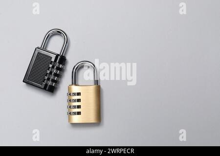 Steel combination padlocks on grey background, top view. Space for text Stock Photo