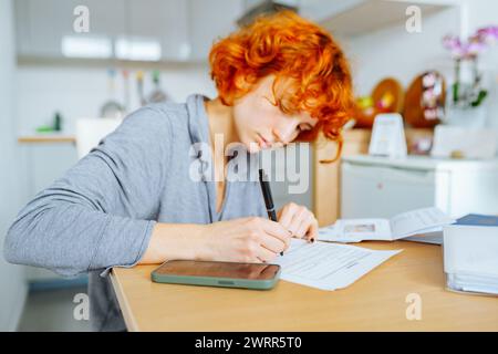 portrait attractive teenage girl filling out paper form Stock Photo