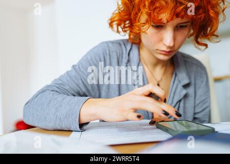 portrait attractive teenage girl filling out paper form Stock Photo