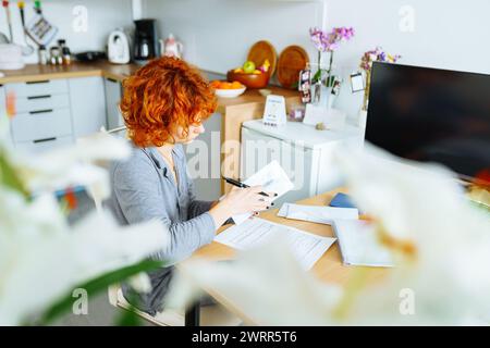 portrait attractive teenage girl filling out paper form Stock Photo