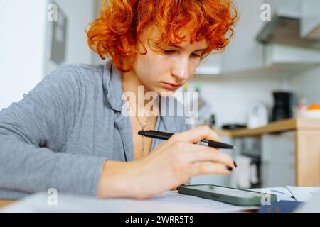 portrait attractive teenage girl filling out paper form Stock Photo