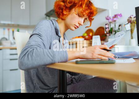 portrait attractive teenage girl filling out paper form Stock Photo