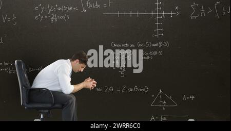 Disappointed man with math equations in dark background for back to school 4k image. Stock Photo