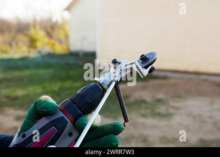 Metal sheet cutter attachment on drill, electric tool of metal cutting. Stock Photo