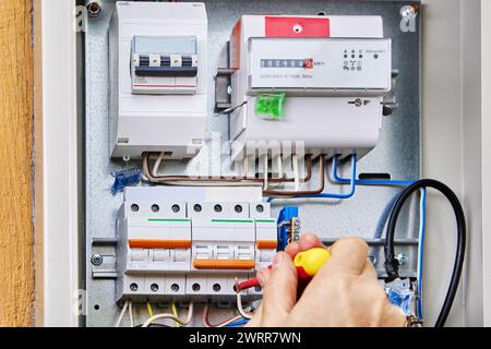 Wiring installation in rural house, connect three-phase power cable for external distribution board. Stock Photo