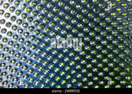 Washing machine drum structure, stainless steel with small holes, abstract industrial background texture Stock Photo