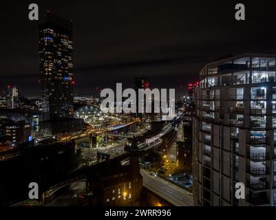 Night time aerial view of the concrete frame of Castle Wharf development under construction and Beetham Tower in Manchester city centre, UK Stock Photo