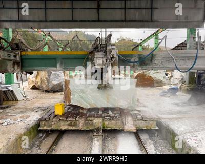 Marble sawing machine in a factory. Cutting marble block. Stock Photo