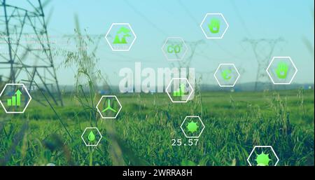 Grassy field with digital eco-friendly icons overlaying Stock Photo