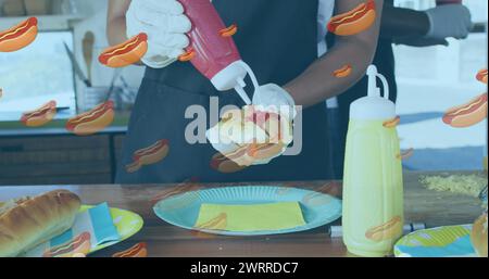 Image of hotdogs over african american male food vendor preparing hotdog in food truck Stock Photo