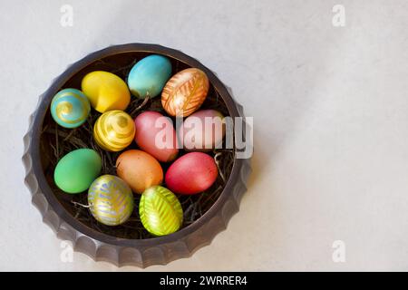 easter centerpiece full of colored  hen eggs view from above, copy space Stock Photo