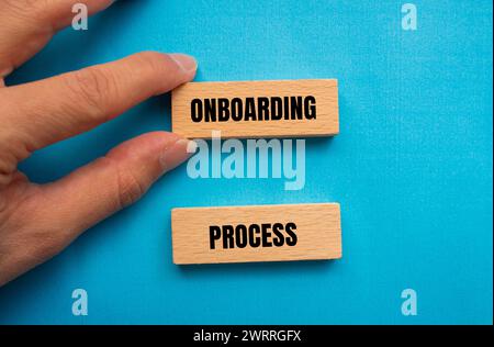 Onboarding process words written on wooden blocks with blue background. Conceptual business symbol. Copy space. Stock Photo