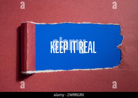 Keep it real words written on red torn paper with blue background. Conceptual symbol. Copy space. Stock Photo