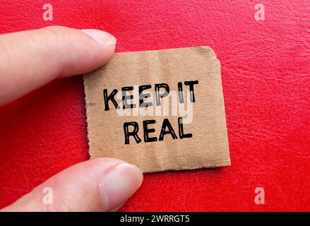 Keep it real words written on torn paper piece with red background. Conceptual symbol. Copy space. Stock Photo