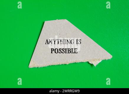 Anything is possible words written on torn paper piece with green background. Conceptual symbol. Copy space. Stock Photo
