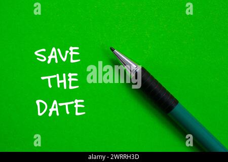 Save the date words written on green paper. Conceptual symbol. Copy space. Stock Photo