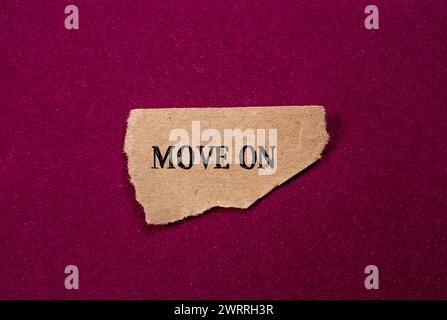 Move on words written on torn paper piece with purple background. Conceptual symbol. Copy space. Stock Photo