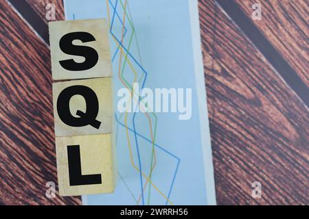 Concept of The wooden Cubes with the word SQL on wooden background. Stock Photo
