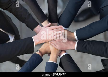 Top view, Cropped view of Group of Business people putting their hands together, Friends with stack of hands showing unity, Teamwork, Success and Unit Stock Photo