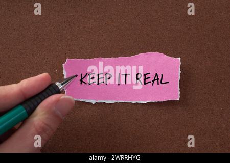 Keep it real words written on pink torn paper with brown background. Conceptual symbol. Copy space. Stock Photo
