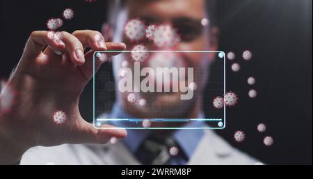 Image of virus orange cells over caucasian male doctor with digital card with virus data Stock Photo
