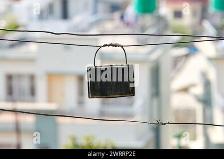 Indian junction box connecting long wires of outdoor wiring system on low rise Indian buildings background, unreliable old wiring without insulation u Stock Photo