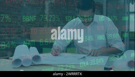 Image of financial data processing over male architect working in office Stock Photo