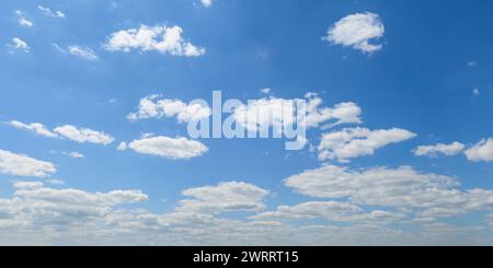 Fluffy white cumulus clouds in the blue sky Stock Photo