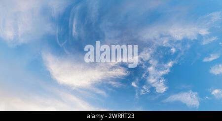 Blue sky at sunset with cirrus clouds and other cloud shapes Stock Photo
