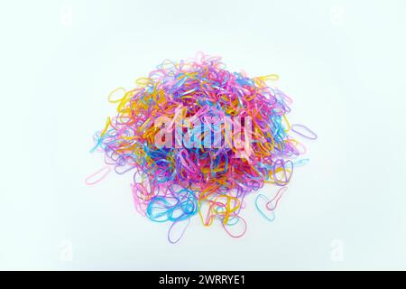 Pile of multicolored rubber hair ties isolated on white background Stock Photo