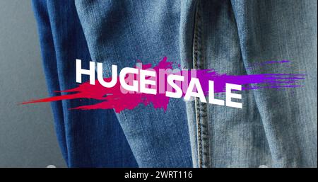 Image of huge sale text over denim trousers background Stock Photo