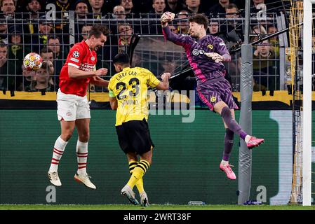 DORTMUND , GERMANY - MARCH 13: Luuk de Jong (PSV), Emre Can (Borussia Dortmund) and Gregor Kobel (Borussia Dortmund) battle for the ball during the UE Stock Photo
