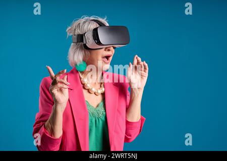 enthusiastic senior woman exploring virtual reality Stock Photo