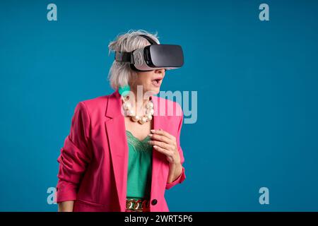 amazed senior woman using virtual reality headset Stock Photo