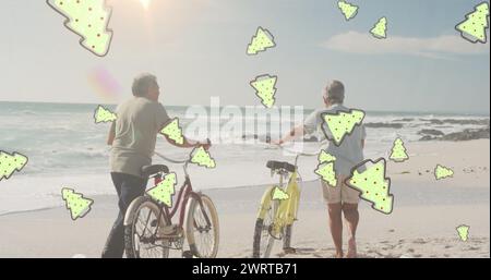 Image of tree cookies over senior biracial couple at beach Stock Photo