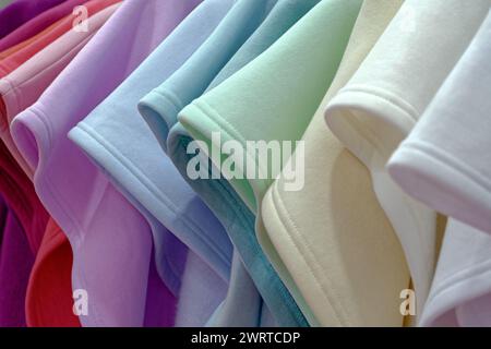 Group of multi-coloured knitted tricot clothing in pastel colours, abstract textile background Stock Photo