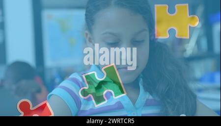 Image of puzzle pieces over biracial schoolgirlusing tablet Stock Photo