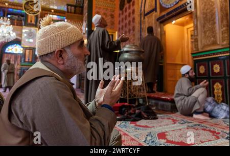 Srinagar, India. 14th Mar, 2024. A Kashmiri Muslim man reads from the ...