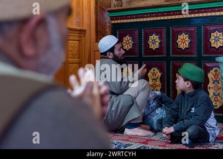 Srinagar, India. 14th Mar, 2024. A Kashmiri Muslim man reads from the ...