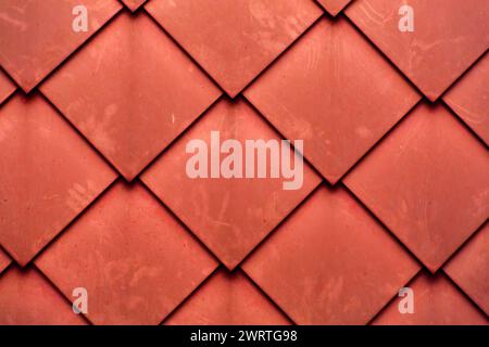 Diamond shaped fish scale tiled wall texture background close up Stock Photo
