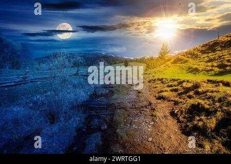 carpathian countryside scenery on spring equinox. mountainous rural landscape beneath a sky with sun and moon. day and night time change concept Stock Photo