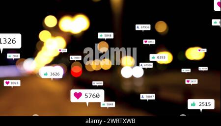 Image of social media icons and numbers over out of focus city lights Stock Photo