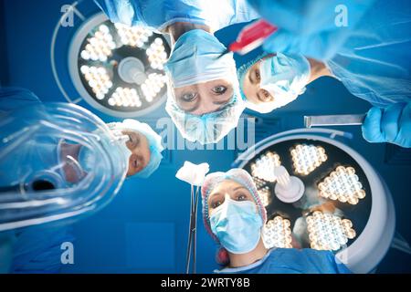 Group of surgeons doctors holding sterile equipment Stock Photo