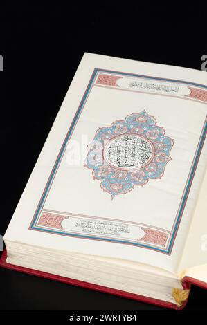 Close up of begin page in Koran book on black studio background Stock Photo